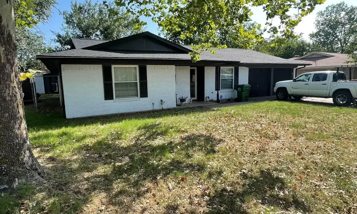 Professional roofing crew working on a residential roof in Kalamazoo